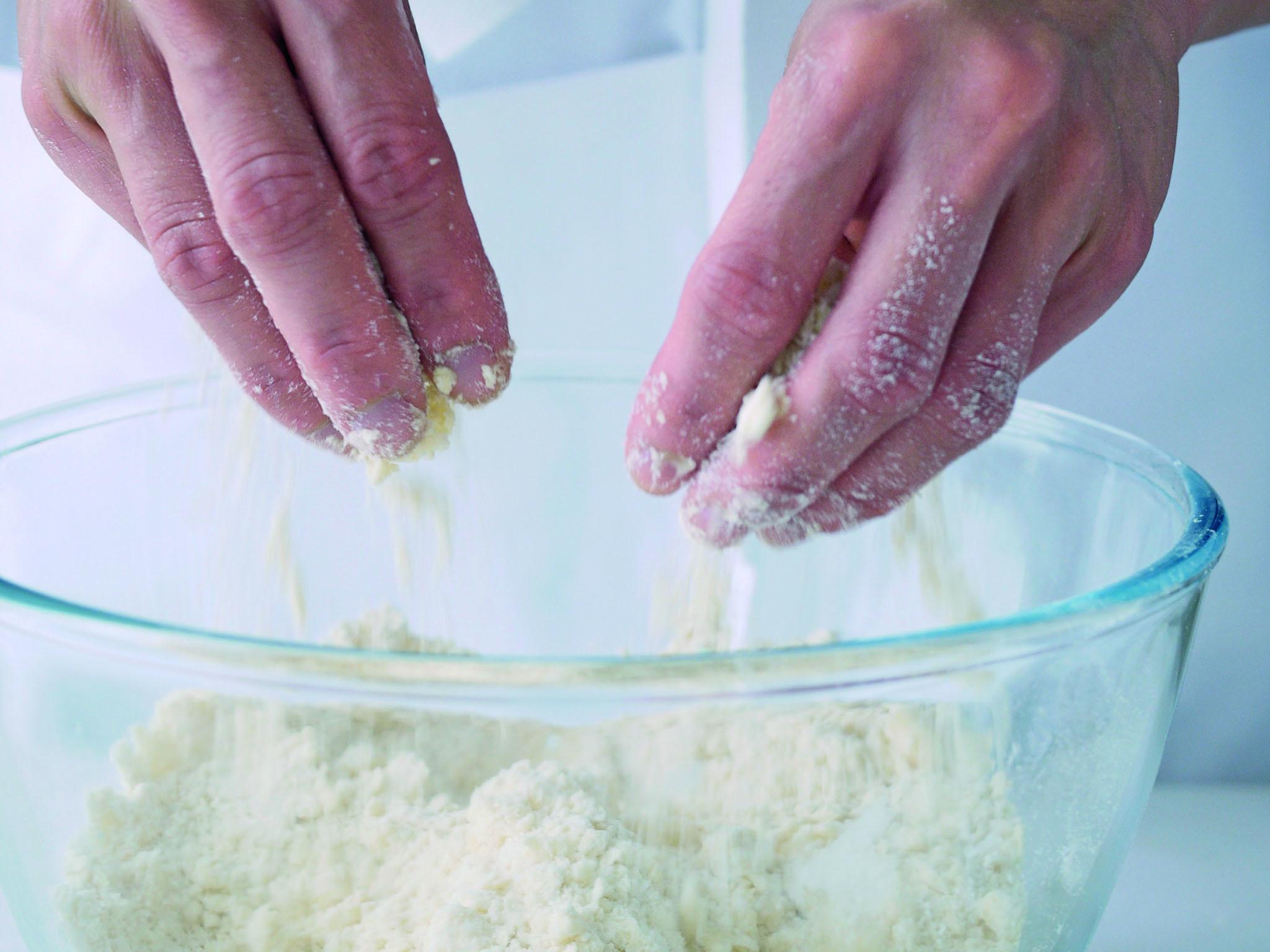 3. Once the butter’ broken down to small pea-sized pieces, use your fingertips to gently rub the little pieces of flour and butter together