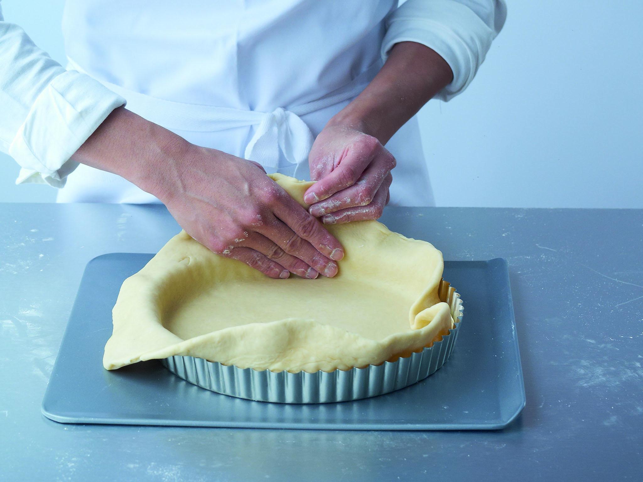 3. Gently lift the overhanging pastry up a little, encouraging the pastry inside the tin or ring to fit snugly, right down to the corners. Now start to lift the edges of the pastry out and over the edge of the tin or ring