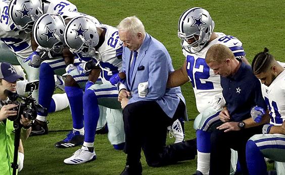 NFL players and their supporters take part in the bent knee protest