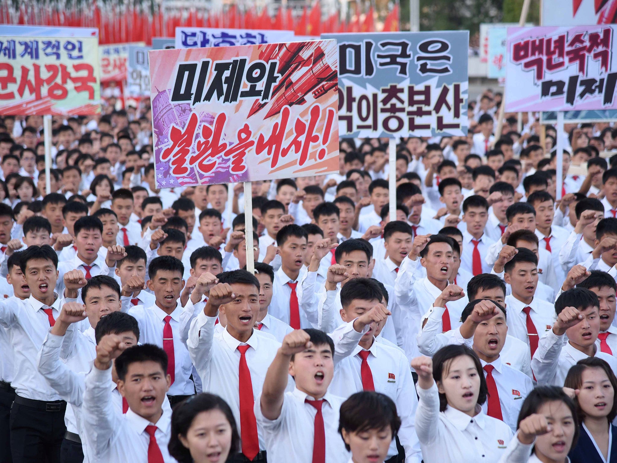 An anti-US rally at Kim Il Sung Square in Pyongyang on September 24. Placards read: 'Be through with the US' and 'The US is evil's headquarters'