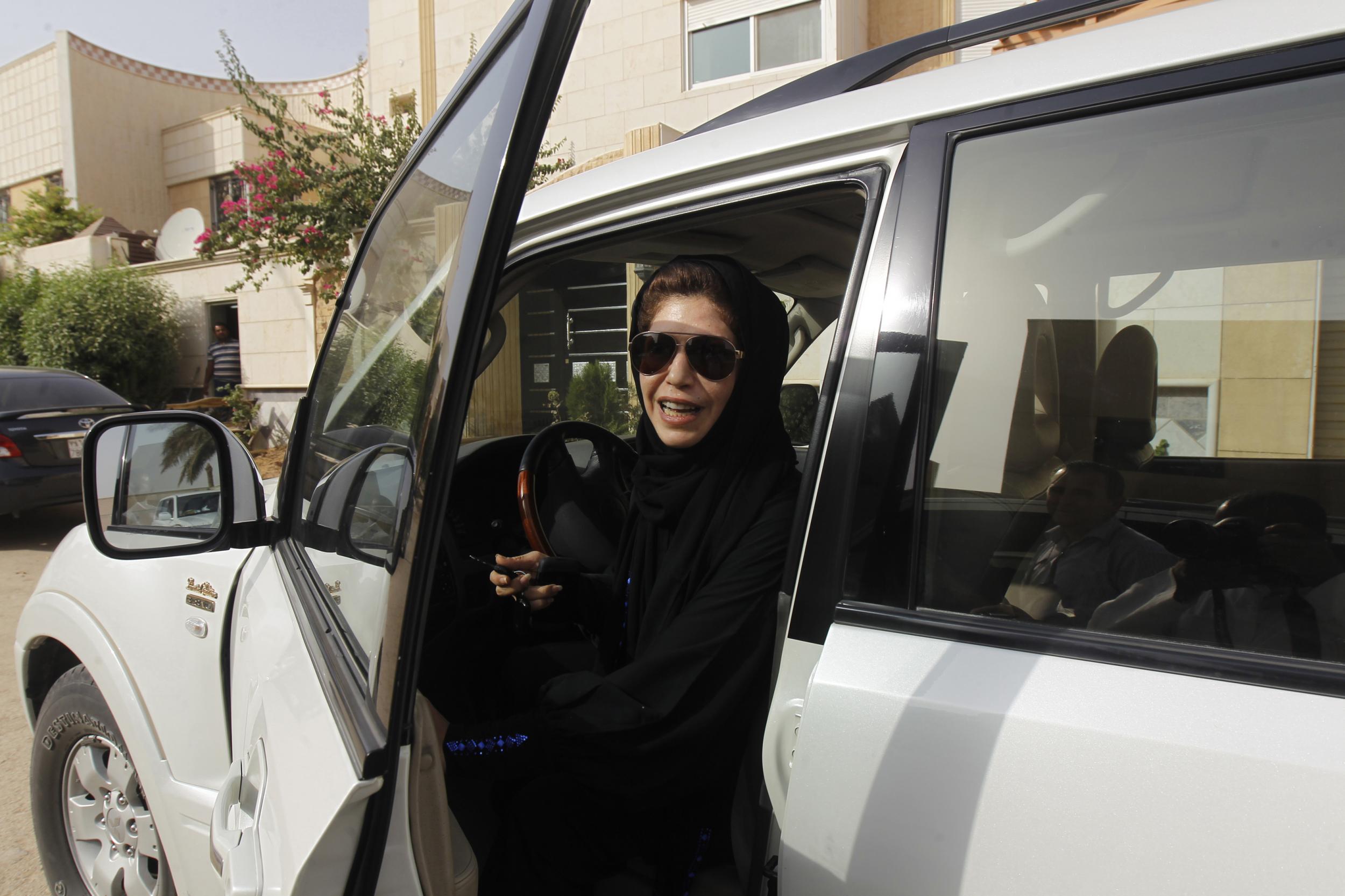 Azza Al Shmasani alights from her car after driving in defiance of the ban on driving licenses for women in Riyadh on 22 June 2011