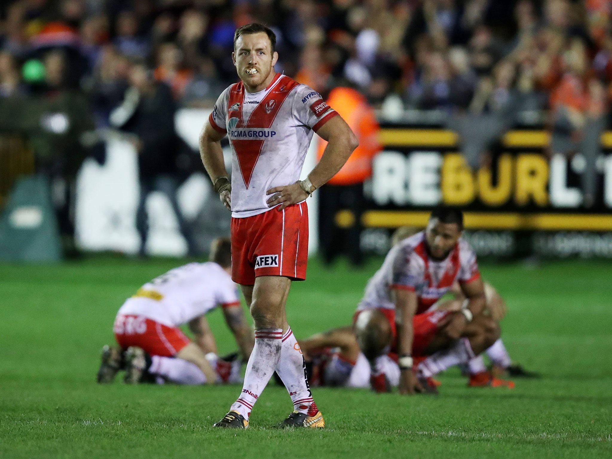 St Helens' dejected players look on after defeat