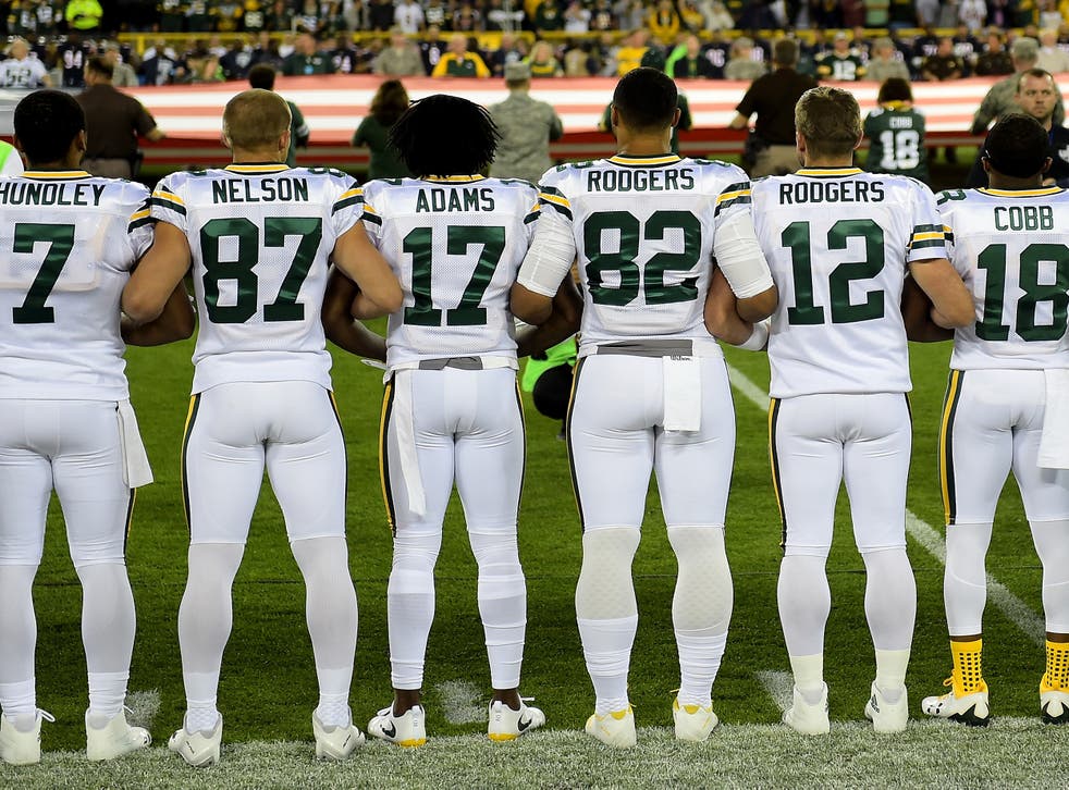 Quarterback Aaron Rodgers (second, right) insisted the gesture was not a protest