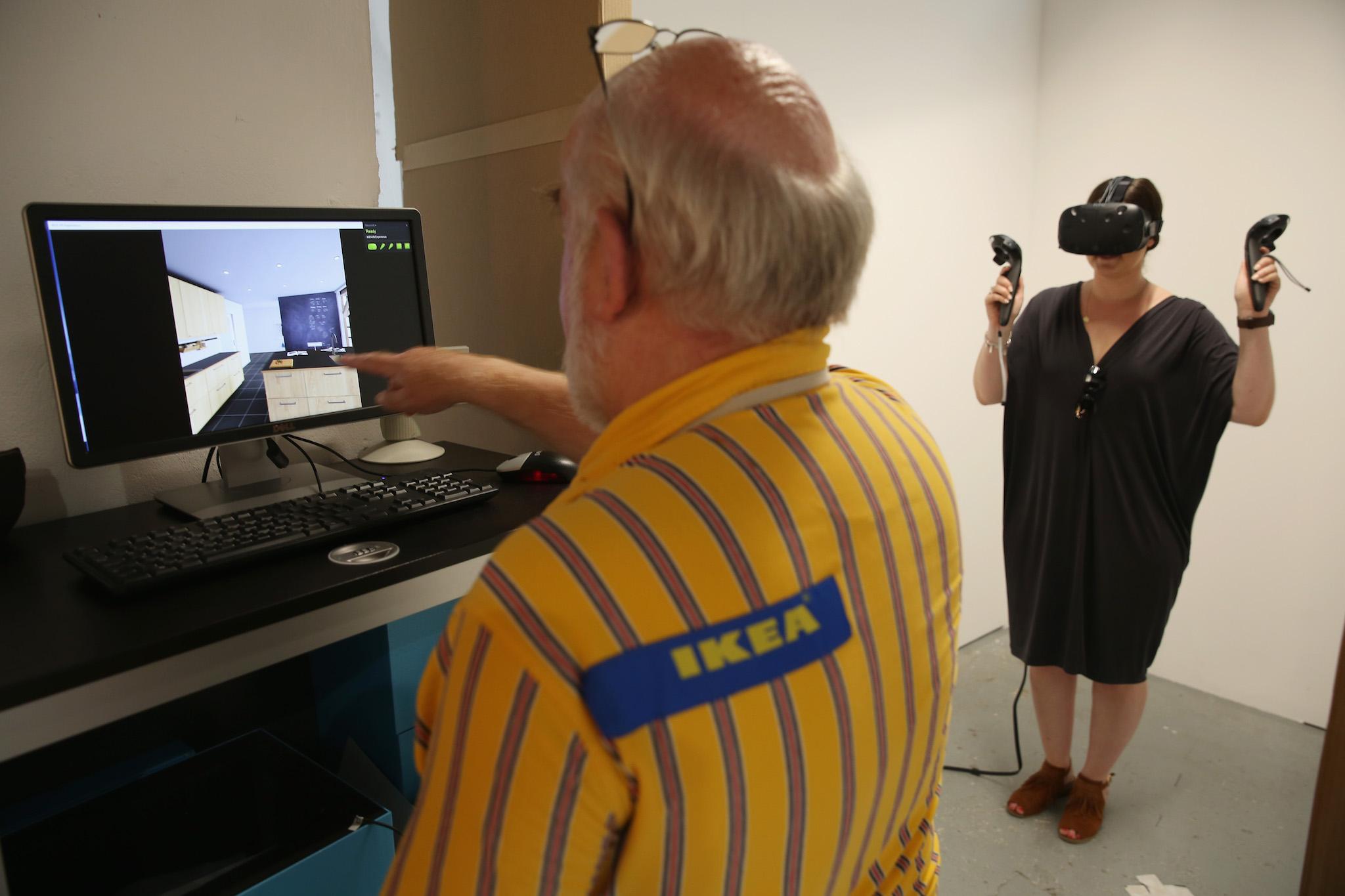 A press officer demonstrates a virtual reality experience inside Ikea's 'The Dining Club' pop up restaurant, cafe and shop in Shoreditch on September 13, 2016 in London, England