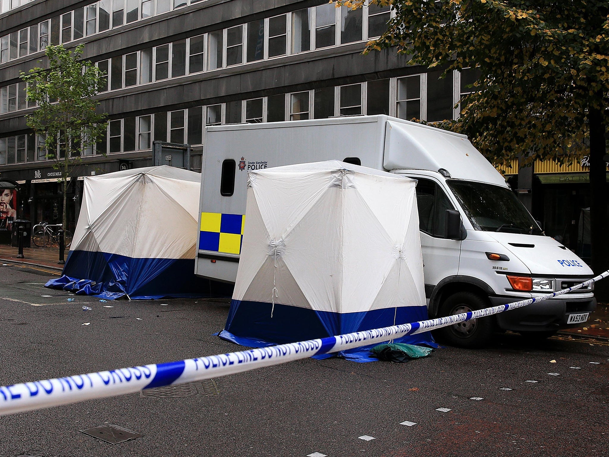 A forensic officer at the scene in Manchester, after a man was stabbed to death in a city centre brawl which left several other people in hospital