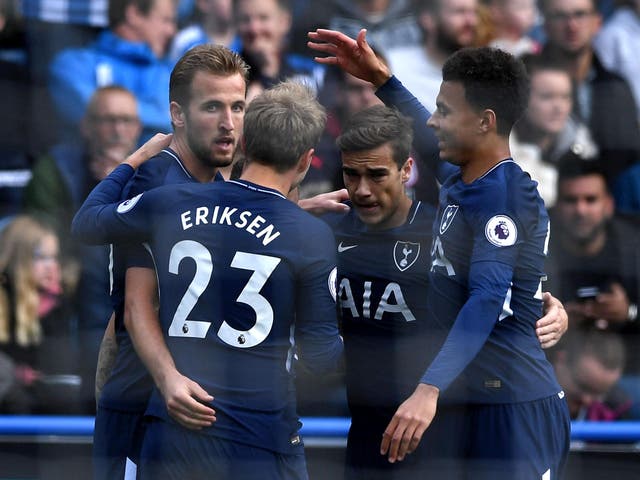 Harry Kane scored twice to defeat Huddersfield Town but Dele Alli was booked for diving