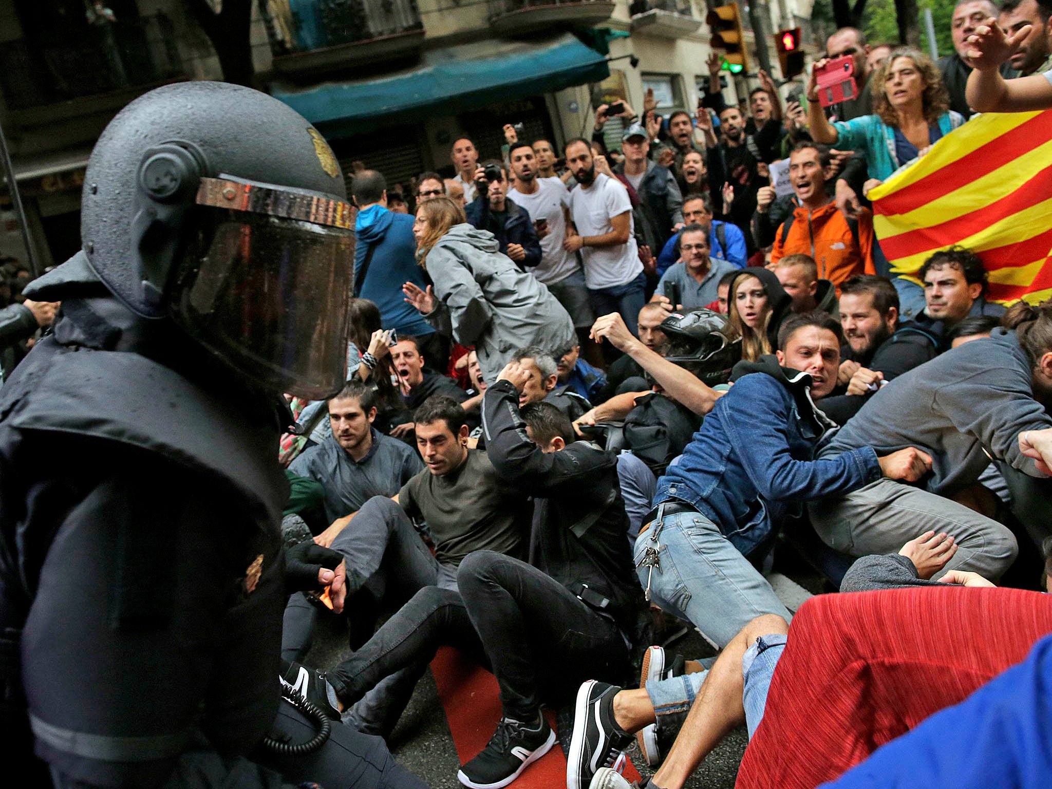 Riot police pushing back Catalans as they try to vote in the referendum