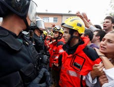 Catalonia firefighters form human shield to protect voters from police