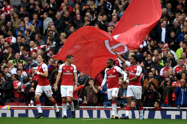Arsenal celebrate Alex Iwobi's goal that secured a 2-0 win over Brighton