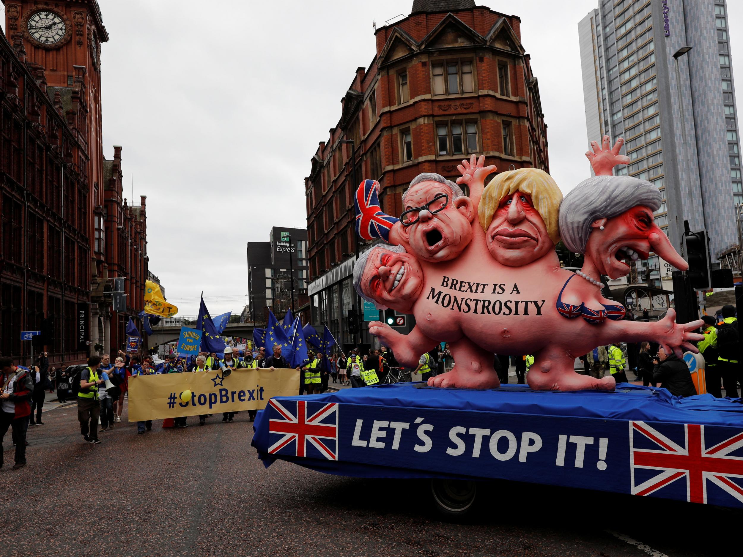 Caricatures of Conservative politicians is driven through Manchester on the opening day of the party conference (Reuters)