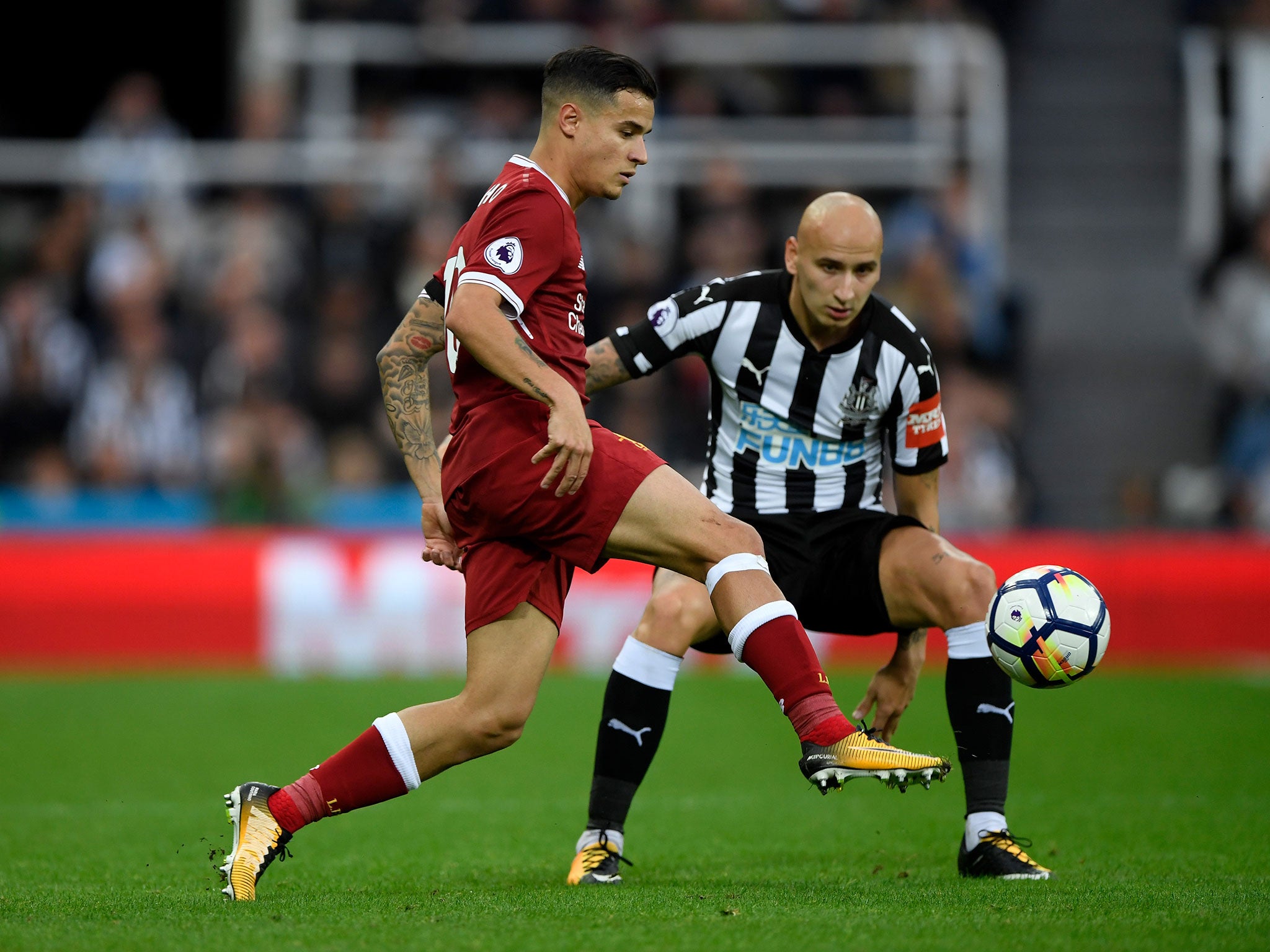 Philippe Coutinho goes up against Jonjo Shelvey