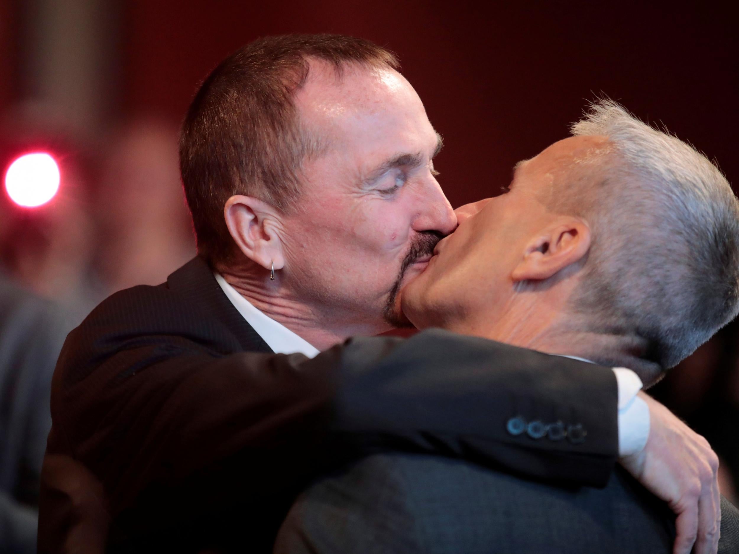 Karl Kreile and Bodo Mende kiss after getting married at a civil registry office, becoming Germany's first married gay couple