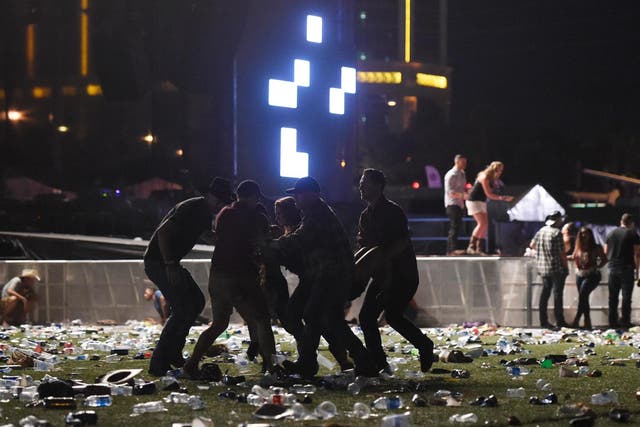 People carry a person at the Route 91 Harvest country music festival after apparent gun fire was heard