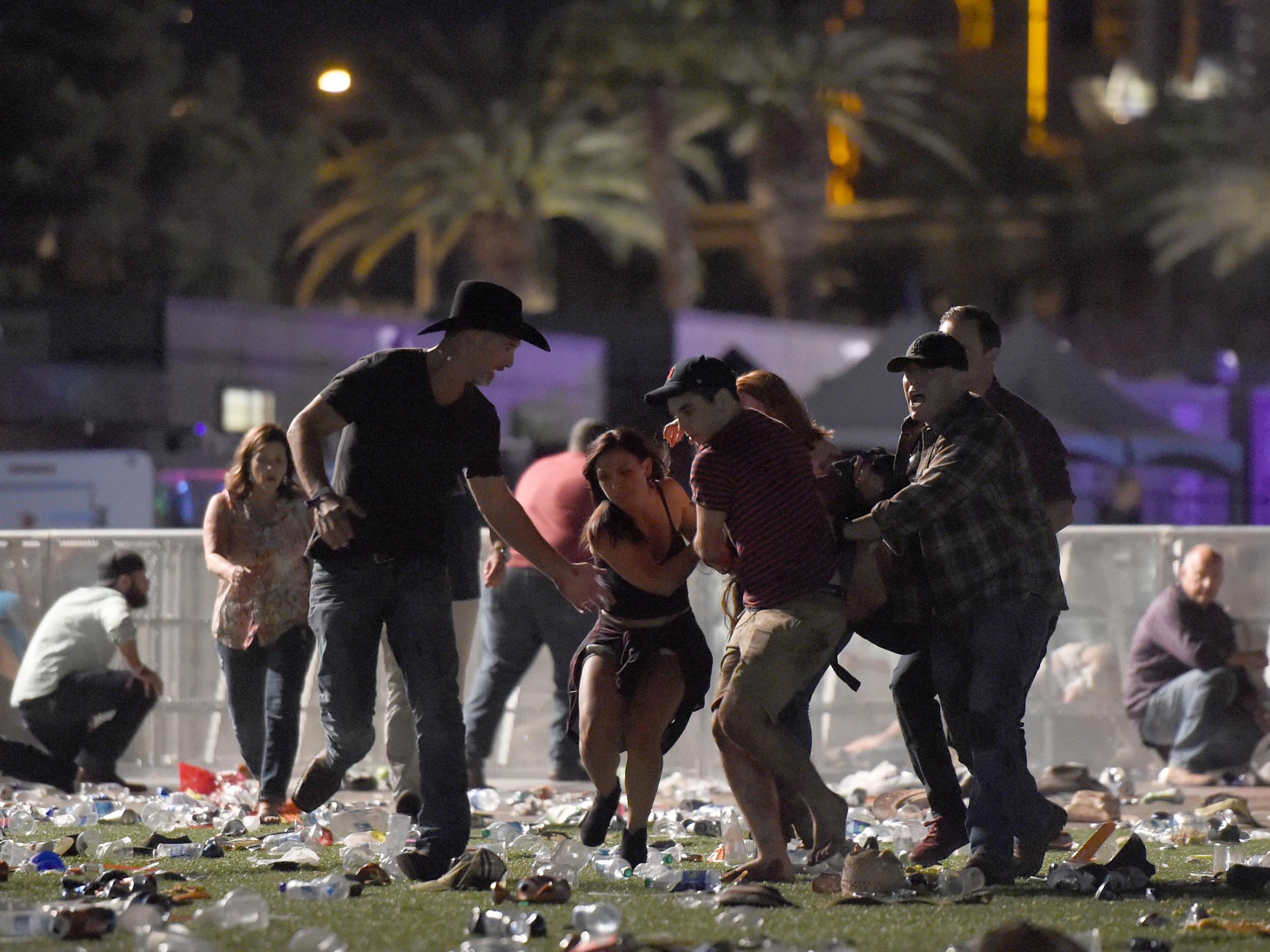 People carry a person at the Route 91 Harvest country music festival after shots were fired