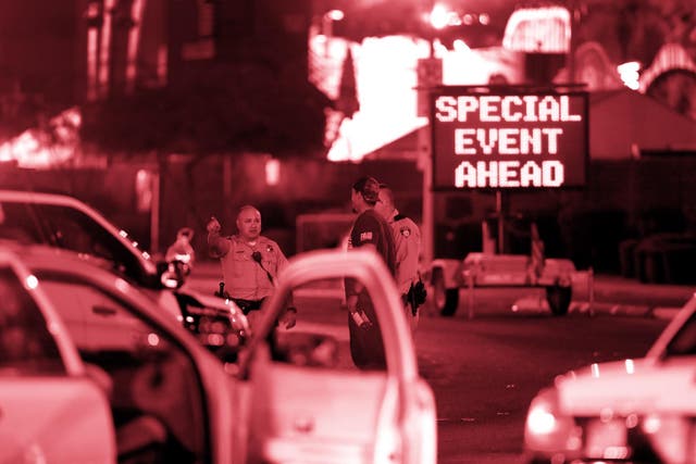 Metro Police officers speak with a man near the concert site on October 2, 2017, after a mass shooting during a music festival on the Las Vegas Strip in Las Vegas, Nevada