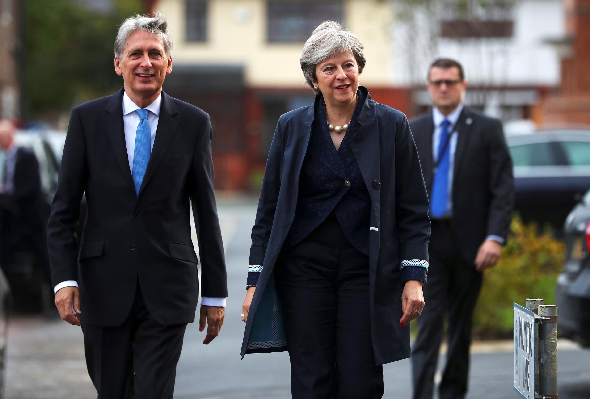 Chancellor Philip Hammond arrives at the Conservative party conference in Manchester, alongside Theresa May
