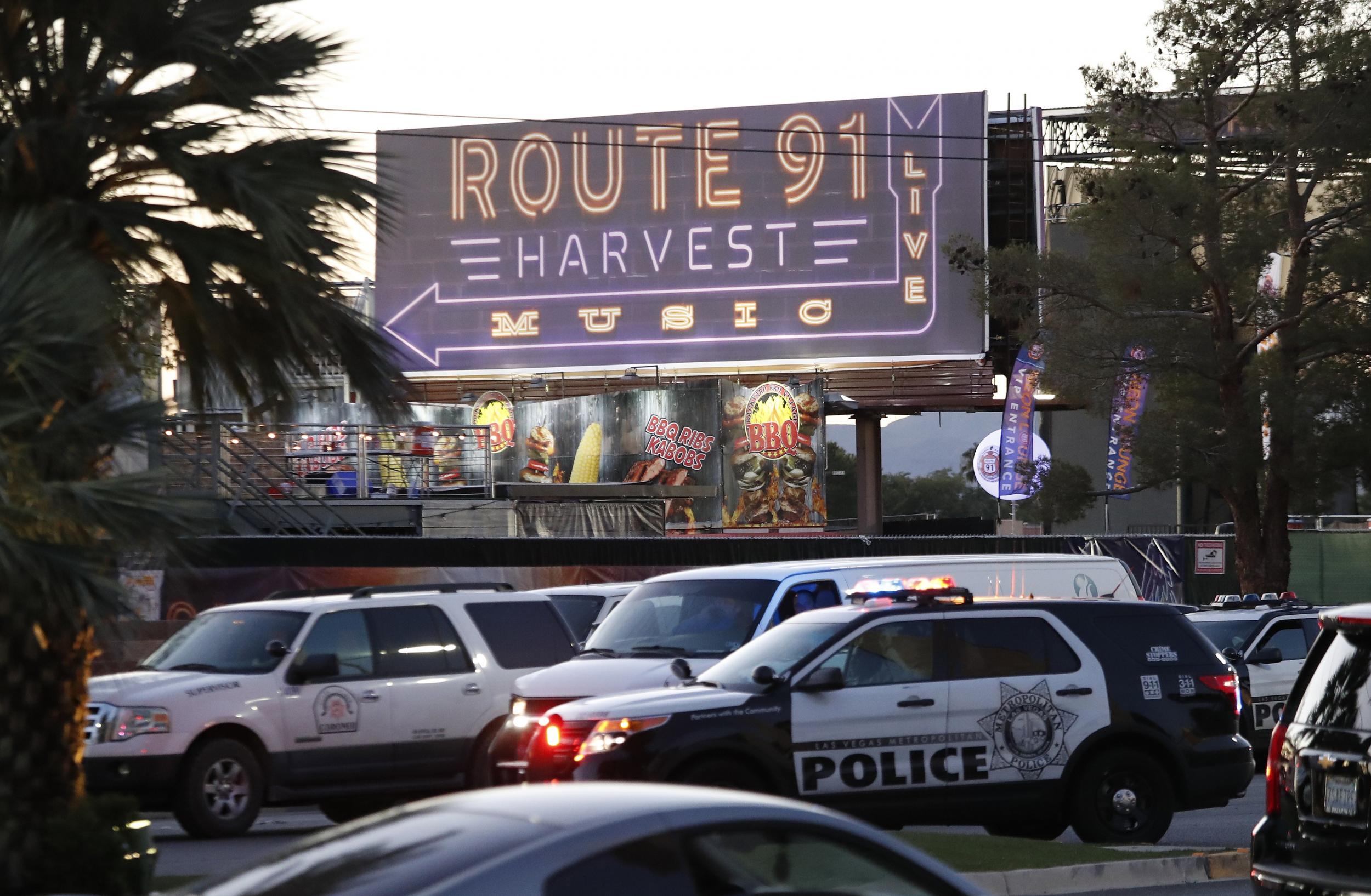 Las Vegas Metropolitan Police in front of a sign for the Route 91 Harvest festival