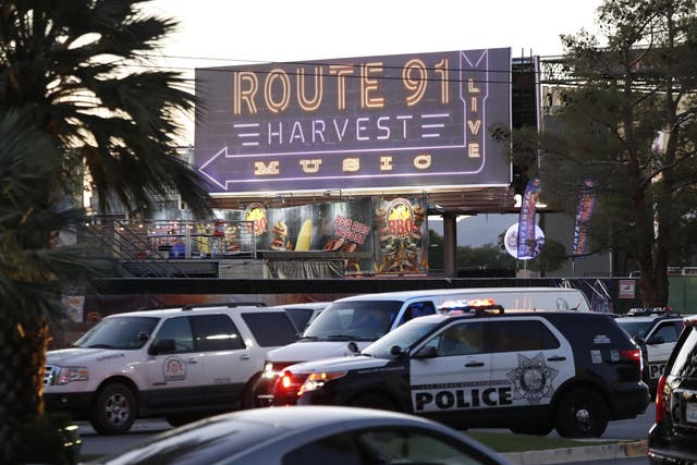Las Vegas Metropolitan Police in front of a sign for the Route 91 Harvest festival