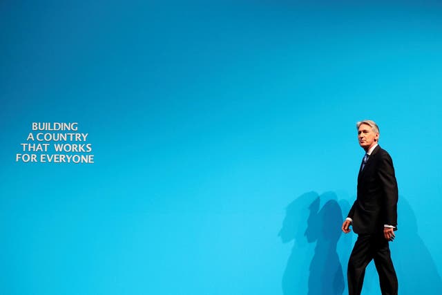 Britain's Chancellor of the Exchequer Philip Hammond arrives to speak at the Conservative Party's conference in Manchester