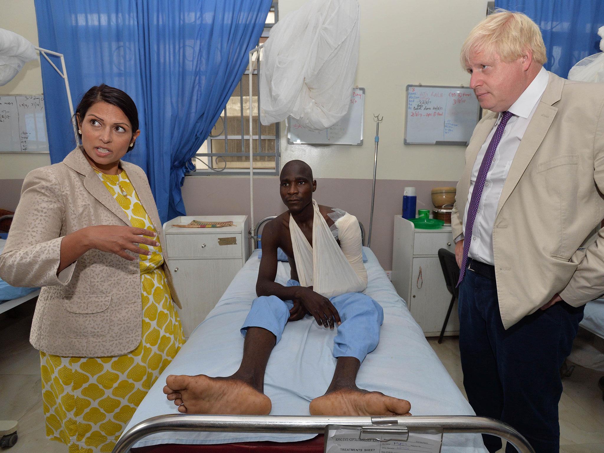 Minister Priti Patel and Foreign Secretary Boris Johnson on a visit to human trafficking victims in Nigeria