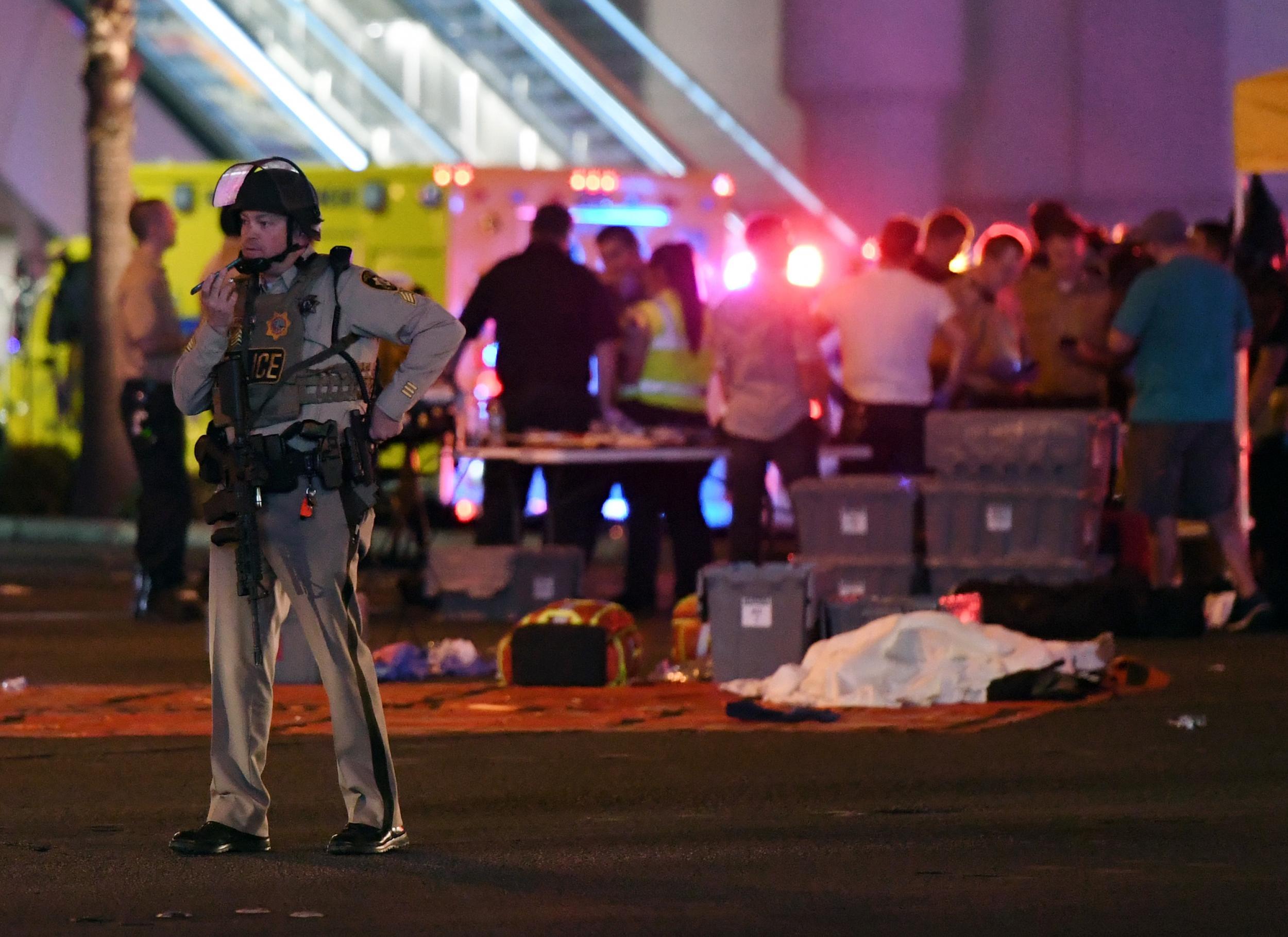 A Las Vegas Metropolitan Police officer stands near the scene of a mass shooting at a country music festival