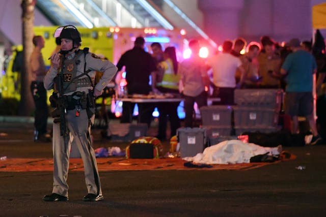 A Las Vegas Metropolitan Police officer stands near the scene of a mass shooting at a country music festival