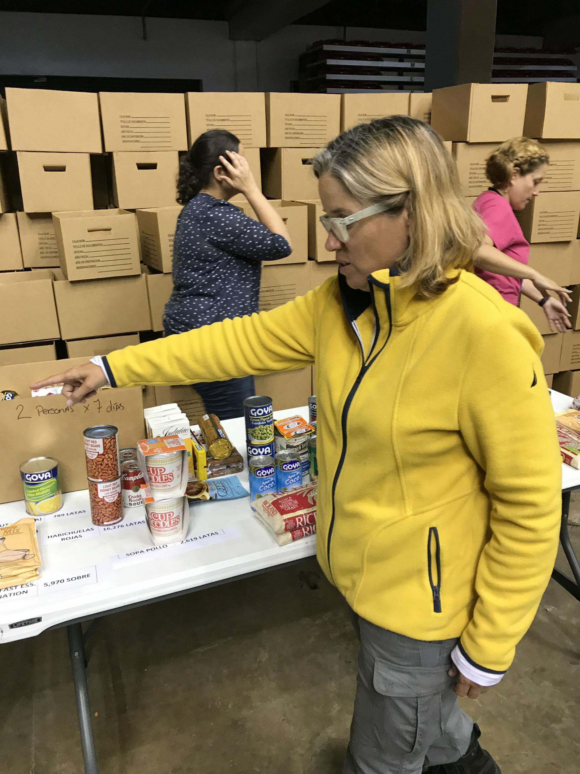 Mayor Carmen Yulin inspects donated food rations at the Coloseo Roberto Clemente in San Juanon the eve of President Trump's visit