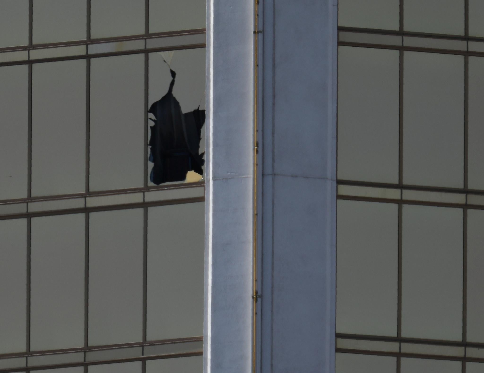 A broken window is seen at The Mandalay Bay Resort and Casino following a mass shooting at the Route 91 Festival