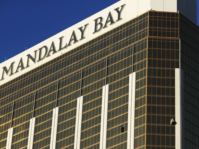 Curtains blow out of windows of the room in the Mandalay Bay hotel used by shooter Stephen Paddock