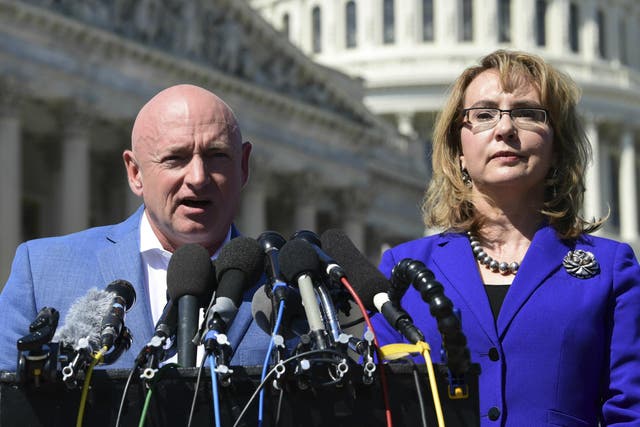 Former Congresswoman Gabrielle Giffords listens as her husband Mark Kelly speaks on Capitol Hill 2 October 2017, about the mass shooting in Las Vegas.
