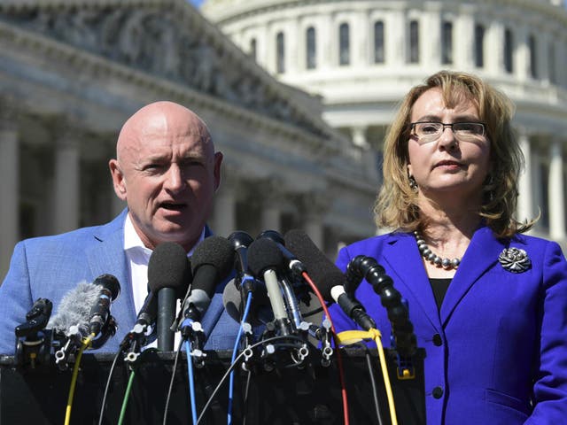 Former Congresswoman Gabrielle Giffords listens as her husband Mark Kelly speaks on Capitol Hill 2 October 2017, about the mass shooting in Las Vegas.