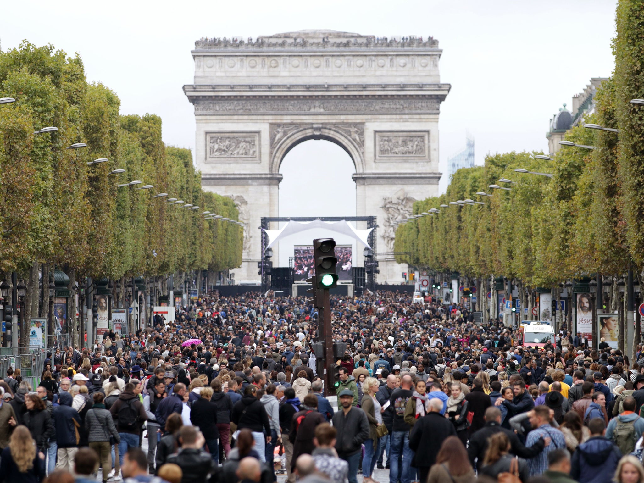 Pedestrians walking along the Champs Elysees during the car free day in Paris