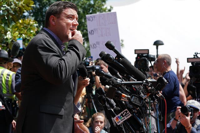 Jason Kessler tries to speak while being shouted down by counter protesters outside the Charlottesville City Hall in August