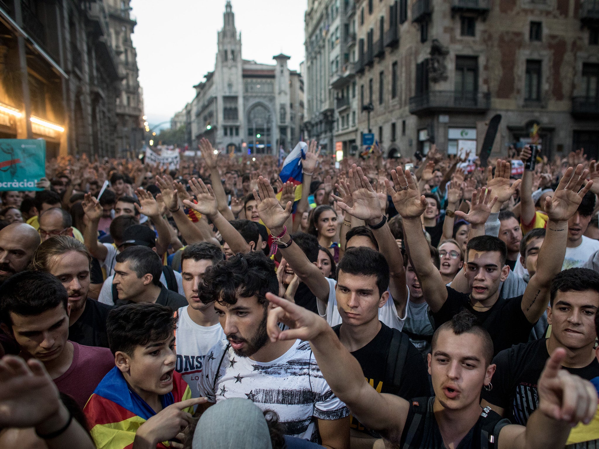 Thousands chant slogans as they gather outside the General Direction of the National Police of Spain building in Barcelona
