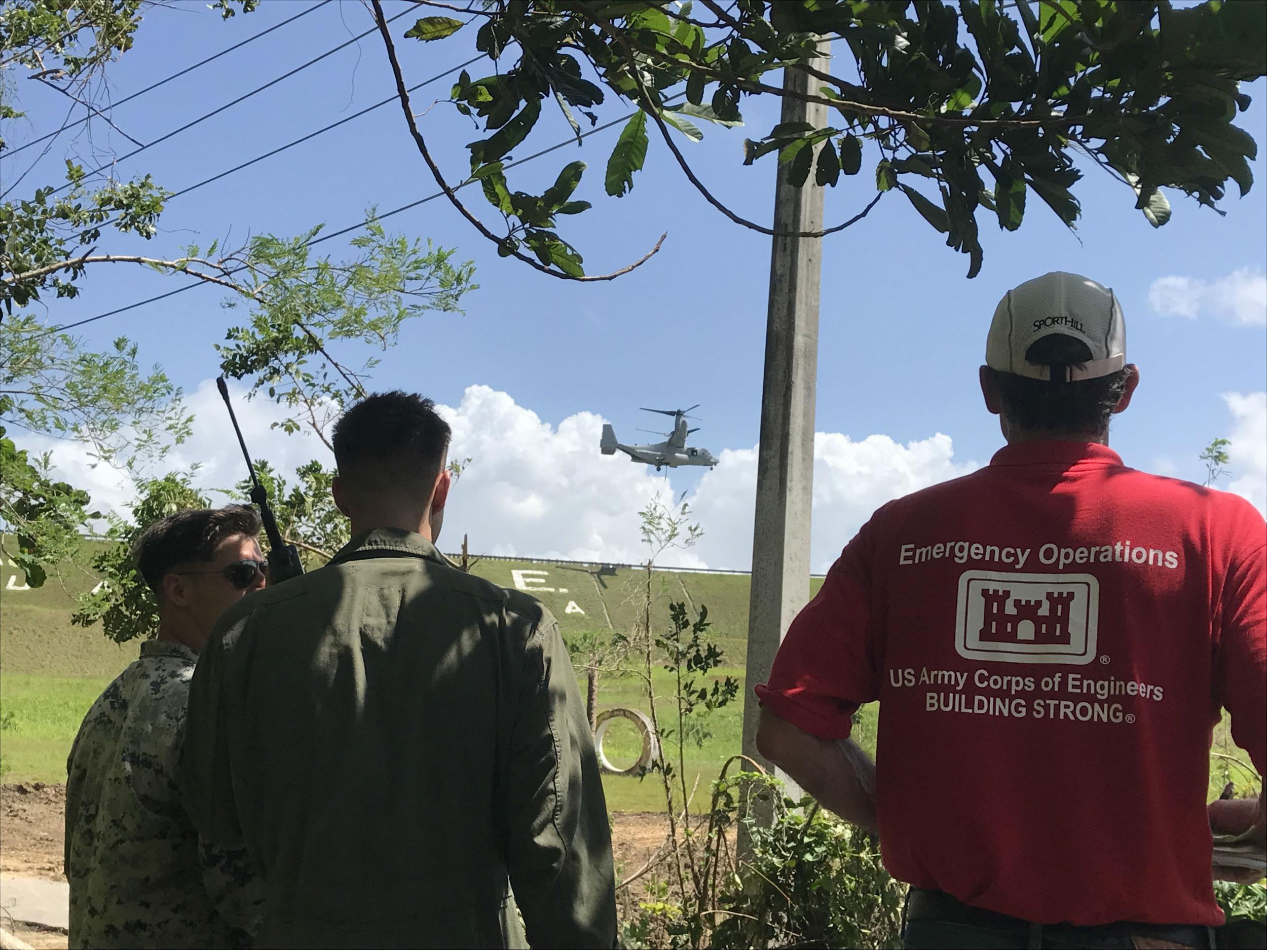 US Army Corps of Engineers near the ruptured spillway are ready to guide the Osprey with its heavy load