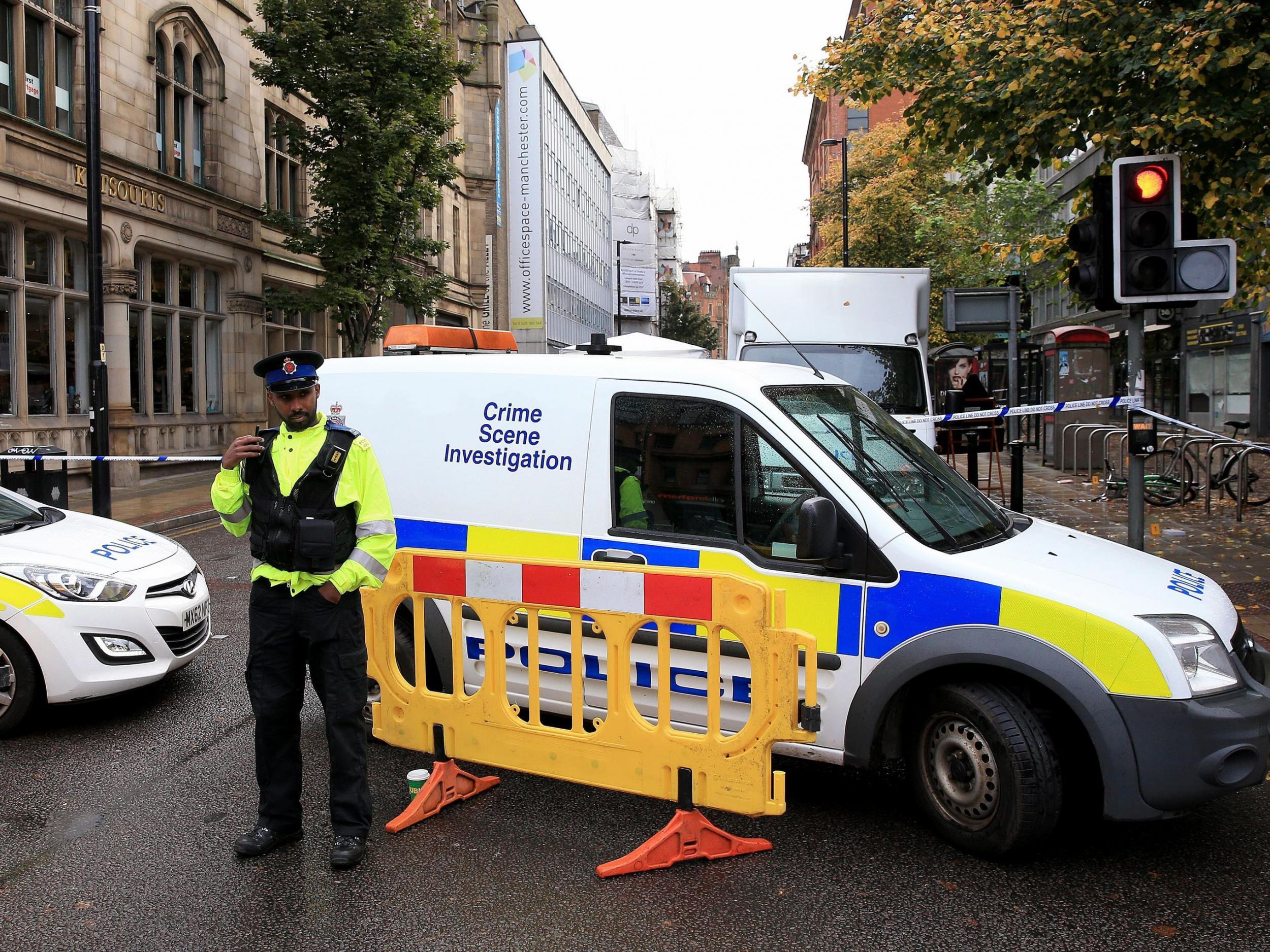 Forensic officers and police at the scene in Manchester City Centre after a man was stabbed to death in a "shockingly violent" city centre brawl that left several other people in hospital