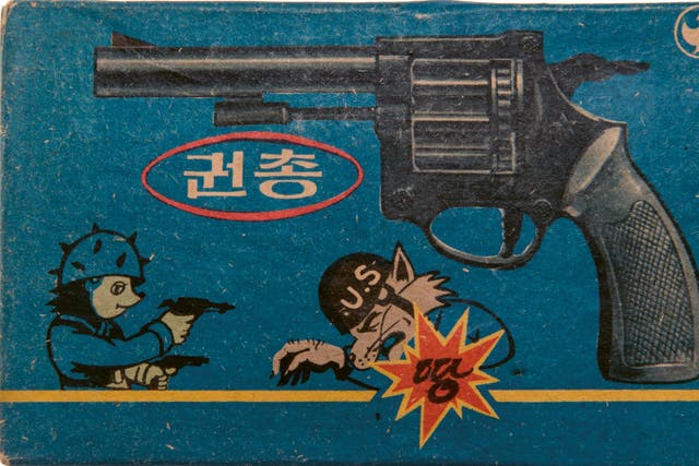 The packaging for a toy gun featuring an anti-US cartoon 
