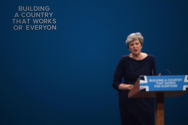 Letters fall off the backdrop as Theresa May speaks during the Tory conference in 2017 (