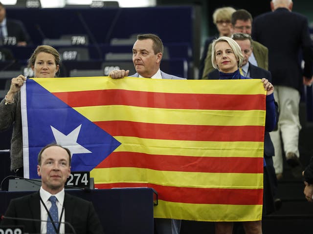 Belgium members of the European Parliament display a Catalan flag in support of the disputed independence movement during a session at the European Parliament on Wednesday