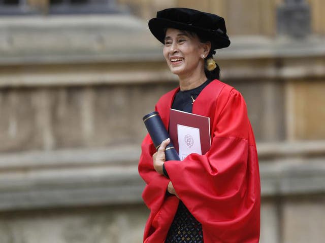Aung San Suu Kyi smiles after receiving an honorary degree at Oxford University in 2012