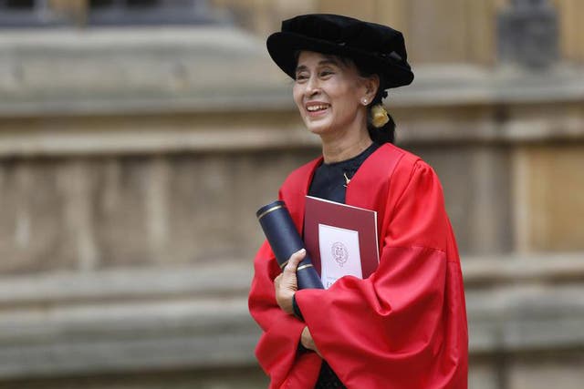 Aung San Suu Kyi smiles after receiving an honorary degree at Oxford University in 2012