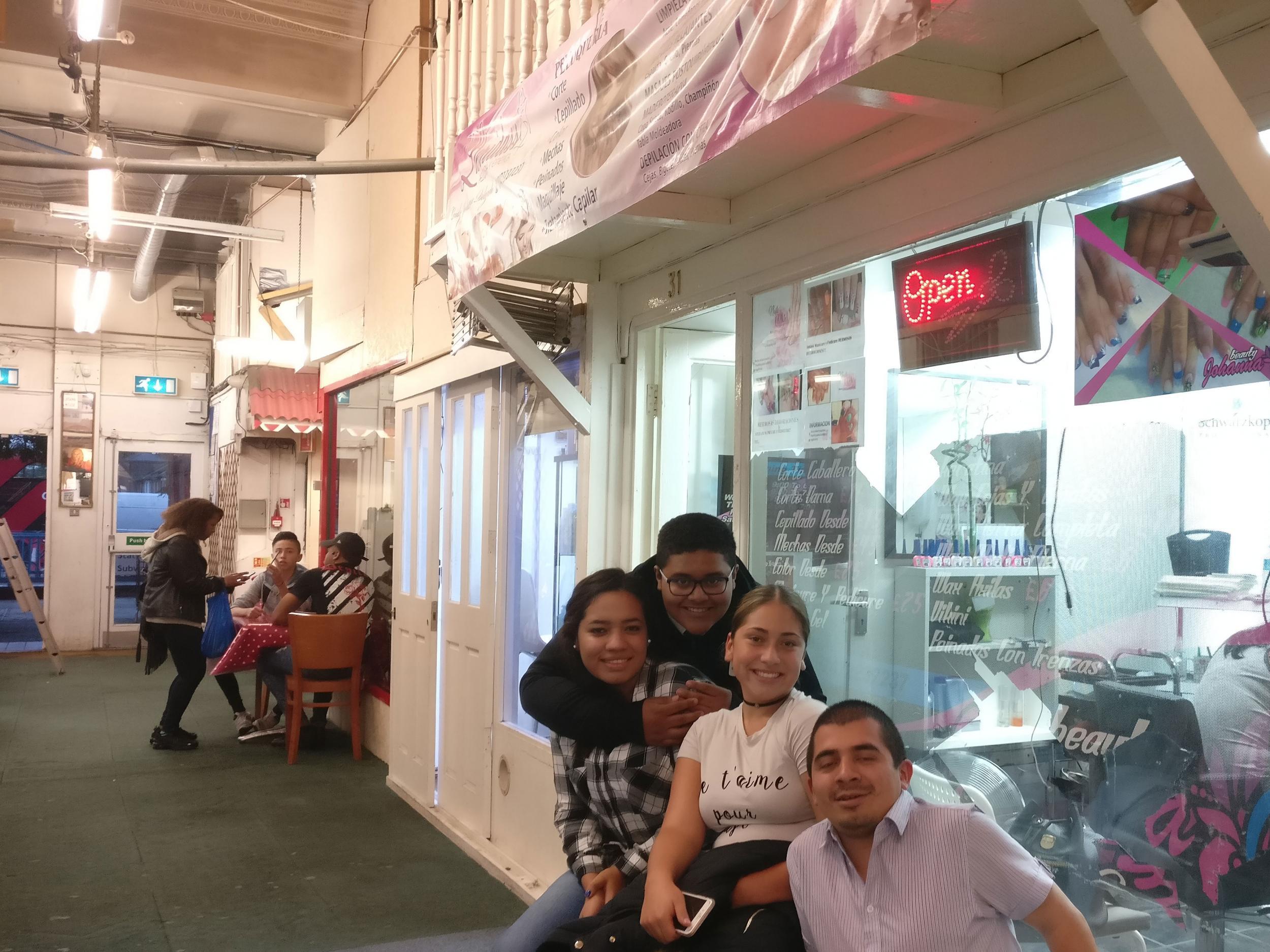 Christian Catano, 13, Dixy Catano, 21, Jessica Agudelo, 16 and Victor ‘Pacho‘ Martinez hang out in the market