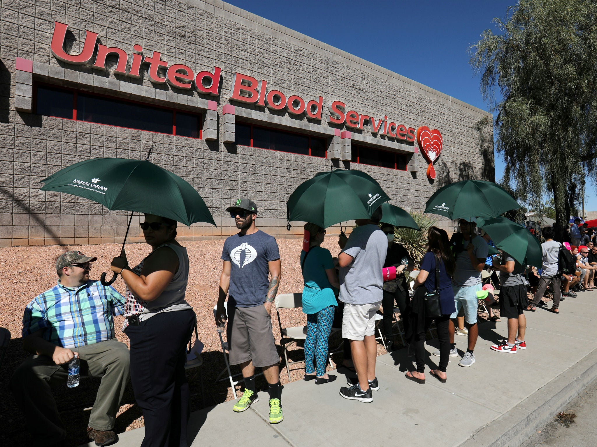 Hundreds of people queue to donate blood following the mass shooting