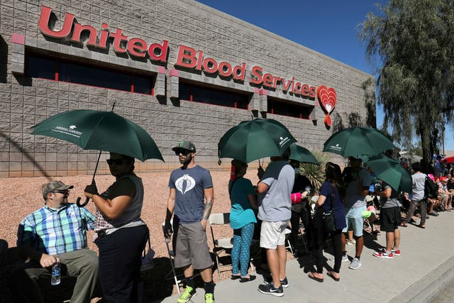 Hundreds of people queue to donate blood following the mass shooting
