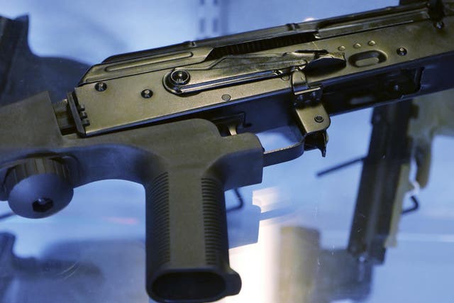A little-known device called a "bump stock" is attached to a semi-automatic rifle at the Gun Vault store and shooting range