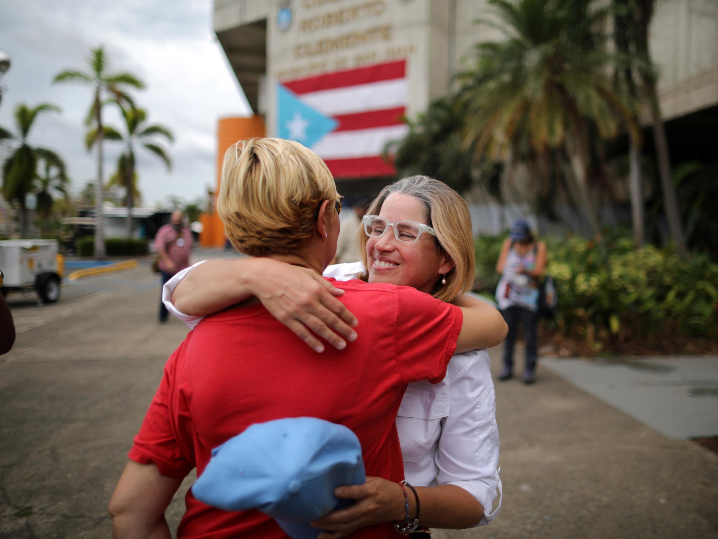 Mayor of San Juan Carmen Yulin Cruz embraces Esperanza Ruiz, a city administrator, outside the government centre at the Roberto Clemente Coliseum after Hurricane Maria in San Juan, Puerto Rico