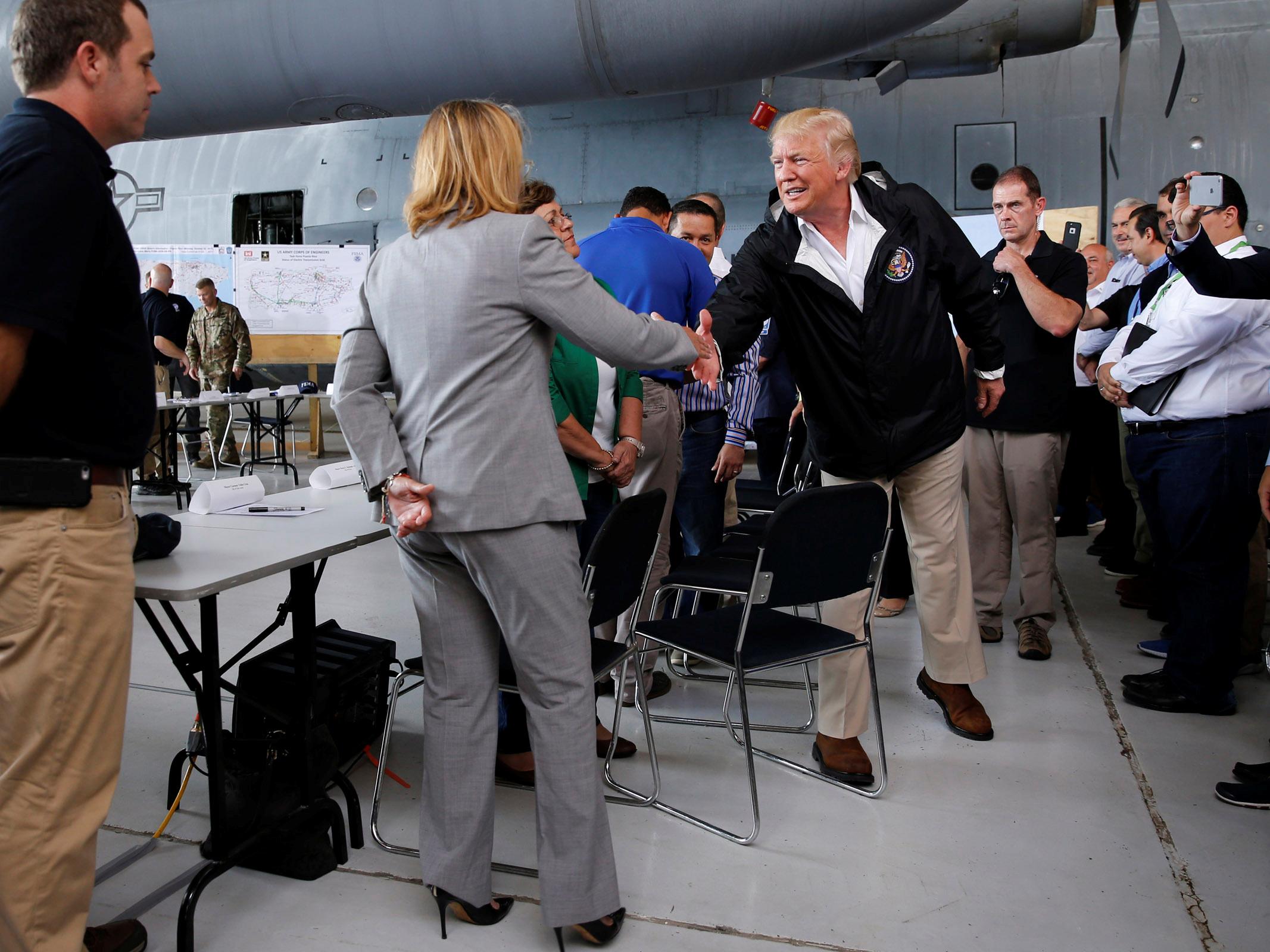 Carmen Yulin Cruz shakes hands with a humbled US President Donald Trump after he criticised her leadership in the the aftermath of Hurricane Maria