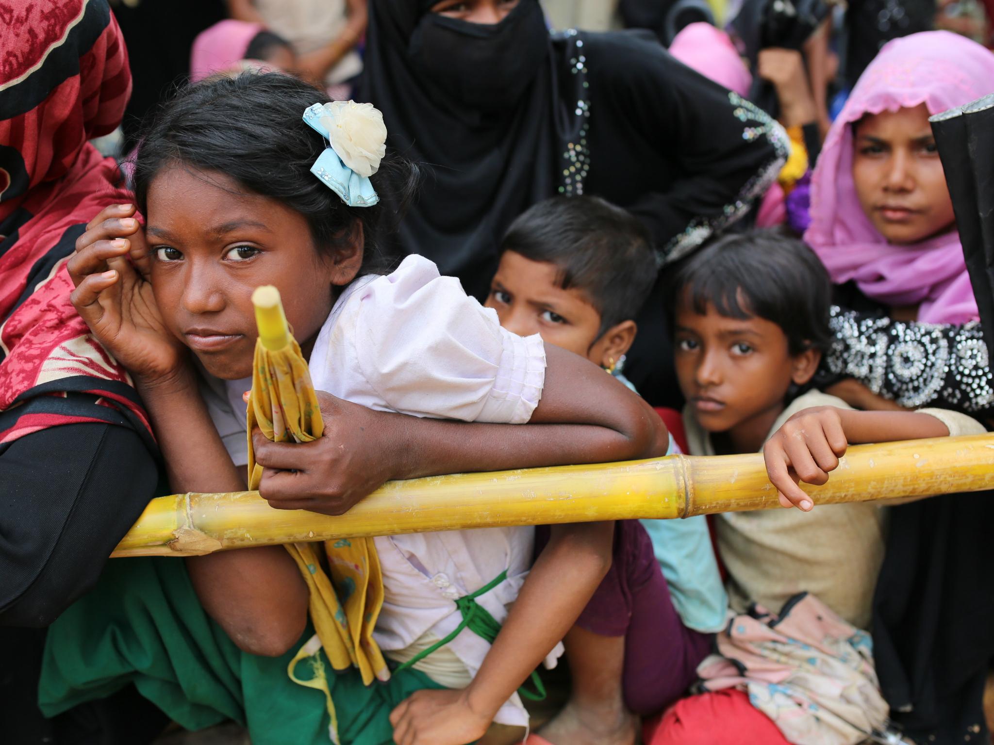 Rohingya children wait for food handouts at Thangkhali refugee camp in Cox's Bazar, Bangladesh, 5 October 2017.