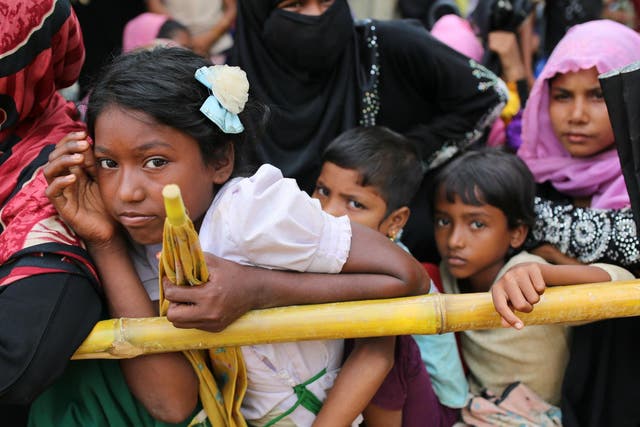 Rohingya children wait for food handouts at Thangkhali refugee camp in Cox's Bazar, Bangladesh, 5 October 2017.