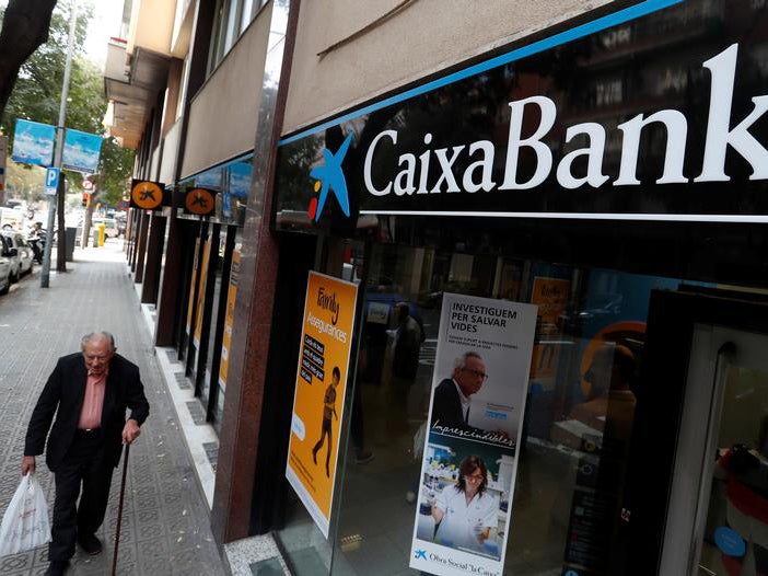 A man walks past a Caixa bank branch in Barcelona, Spain October 6, 2017. REUTERS/Yves Herman